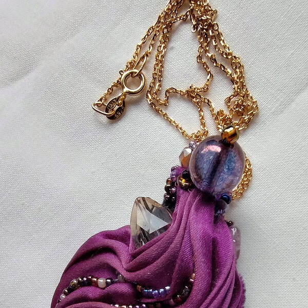 Ann Recotta "Bubble Tea" (View A) handmade bead embroidered pendant with Swarovski crystal, Czech glass beads, Japanese seed beads, pearl, shibori dyed silk ribbon, Ultrasuede, nylon thread with accompanying gold plated sterling silver chain 3.25"x1.5" pendant size $80.