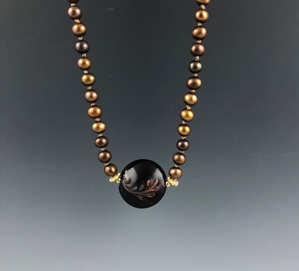 Becky Congdon "Grecian Wheat Necklace" handmade flameworked lentil-shaped glass bead with hand strung and individually knotted topaz and golden pearls gold-filled accent beads and findings 20" length $115. SOLD