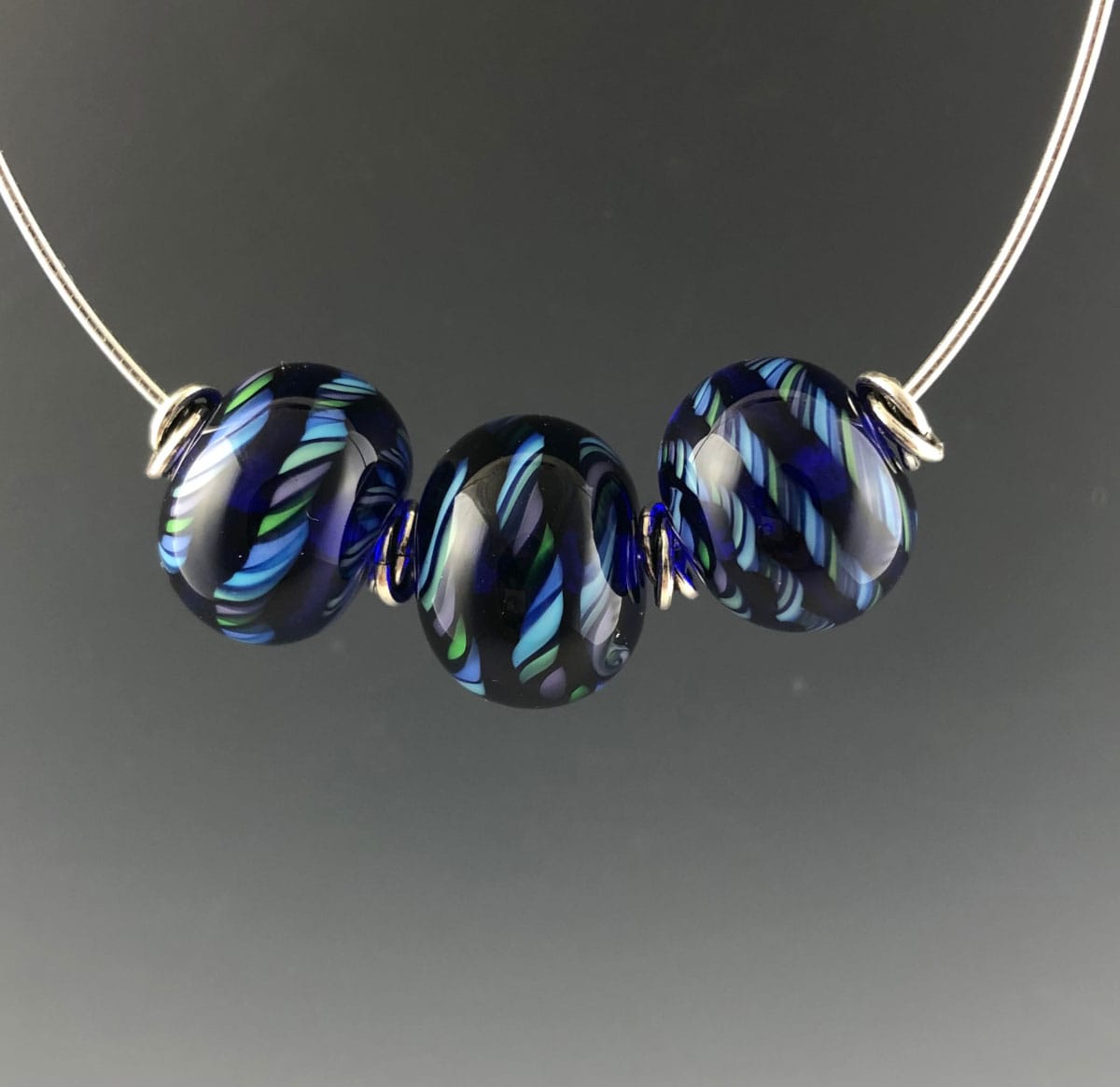 Becky Congdon "Mardi Gras Twist Omega" handmade flameworked glass beads with sterling silver findings and chain 18" $120.