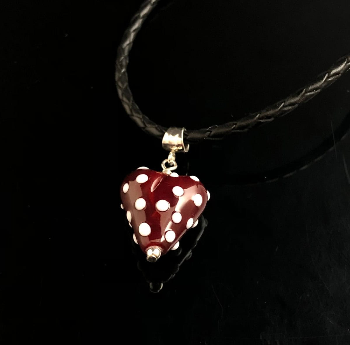 Becky Congdon "Spirited Heart Necklace" handmade flameworked heart-shaped glass bead, sterling silver findings on braided leather cord necklace 18" length $95. SOLD