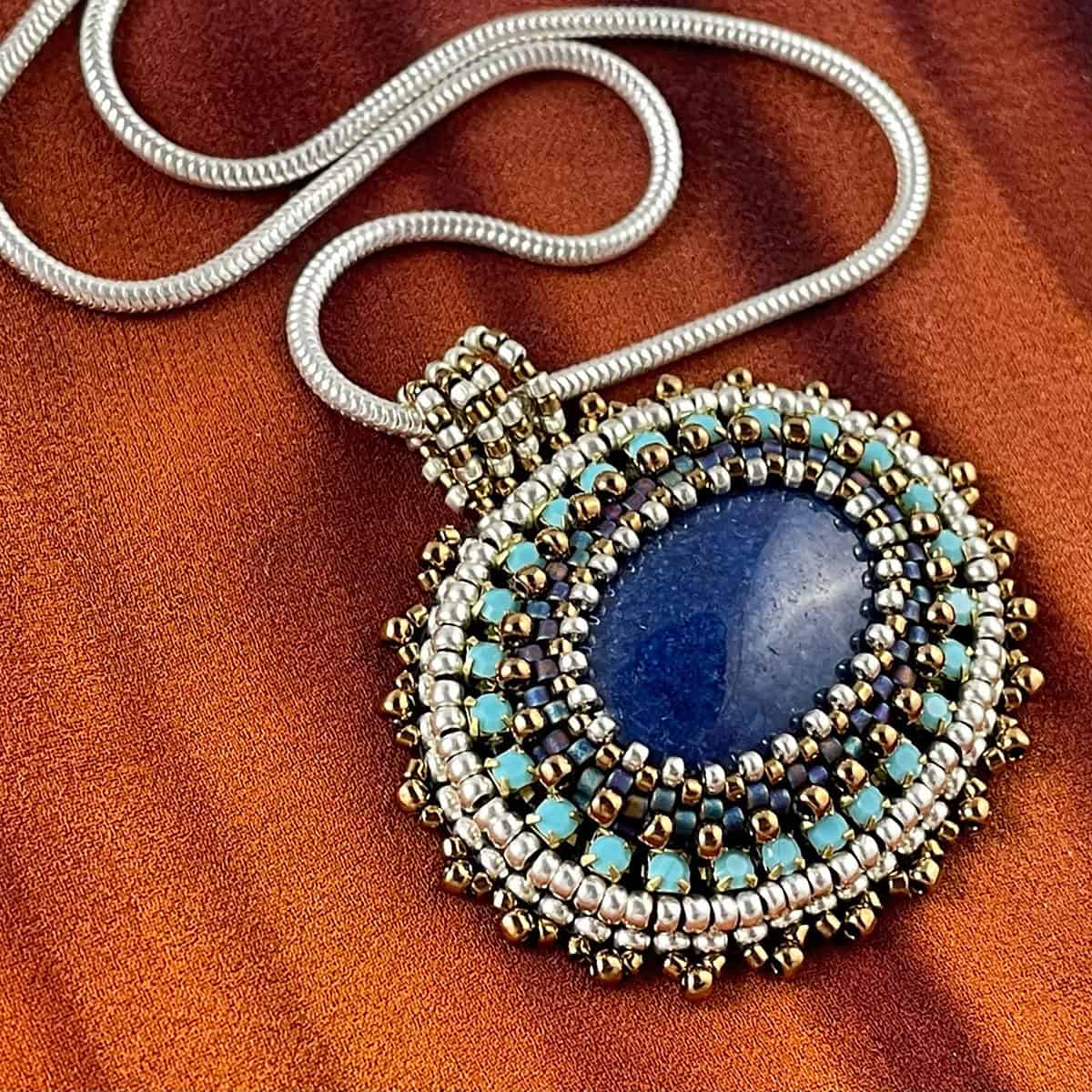 San Fortune "Lapis Pendant" bead embroidery with lapis and various glass beads on 18" sterling silver snake chain $140. SOLD