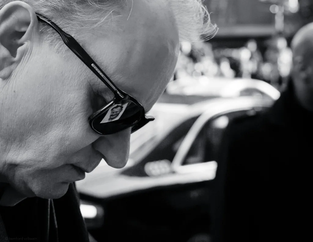 Thoughtful black and white portrait of Stellan Skarsgård at Berlinale, wearing sunglasses with a pensive expression – part of the exhibition 'The Unseen Scene'.