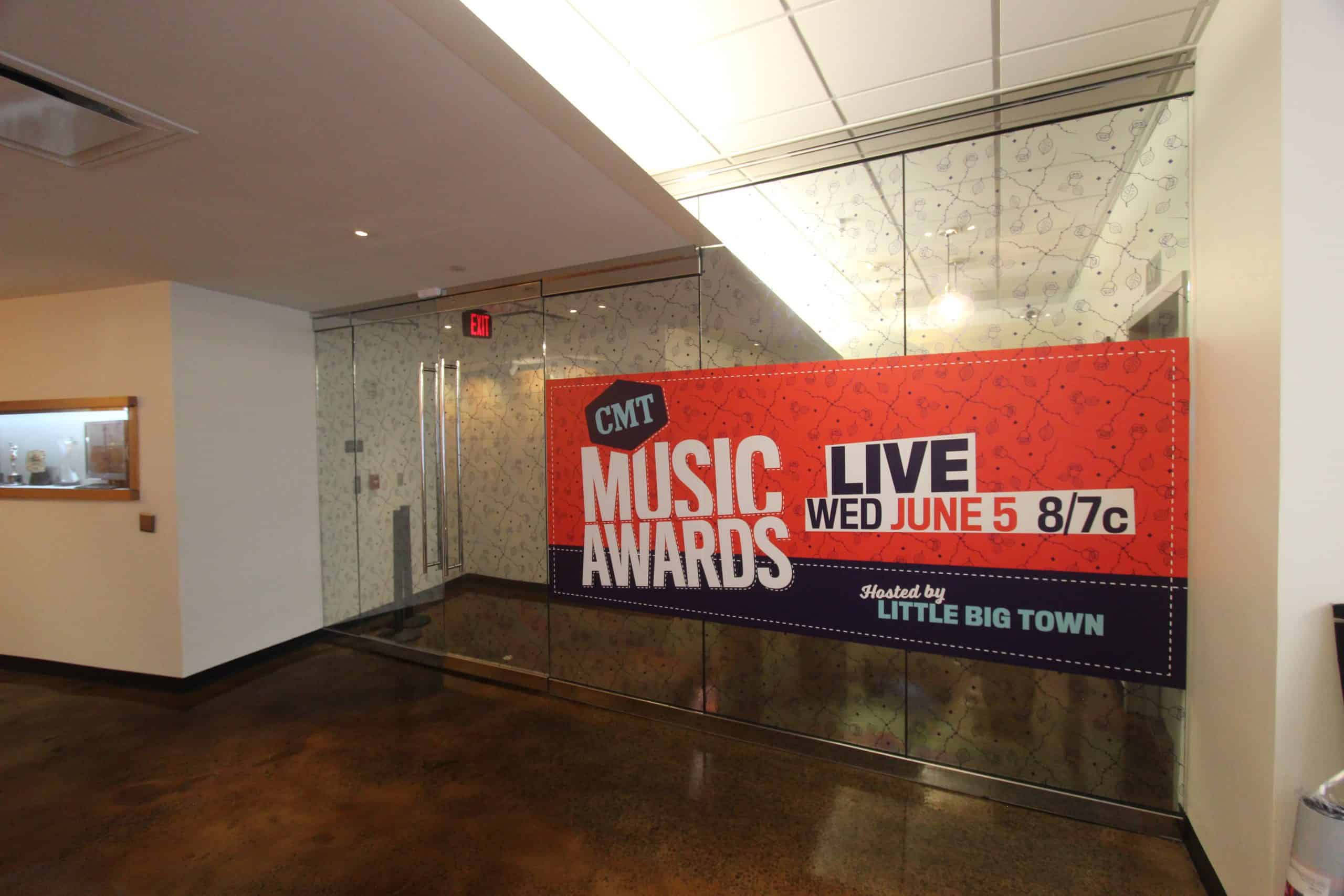 CMT Music Awards poster on glass doors, live June 5, 8/7c, hosted by Little Big Town.