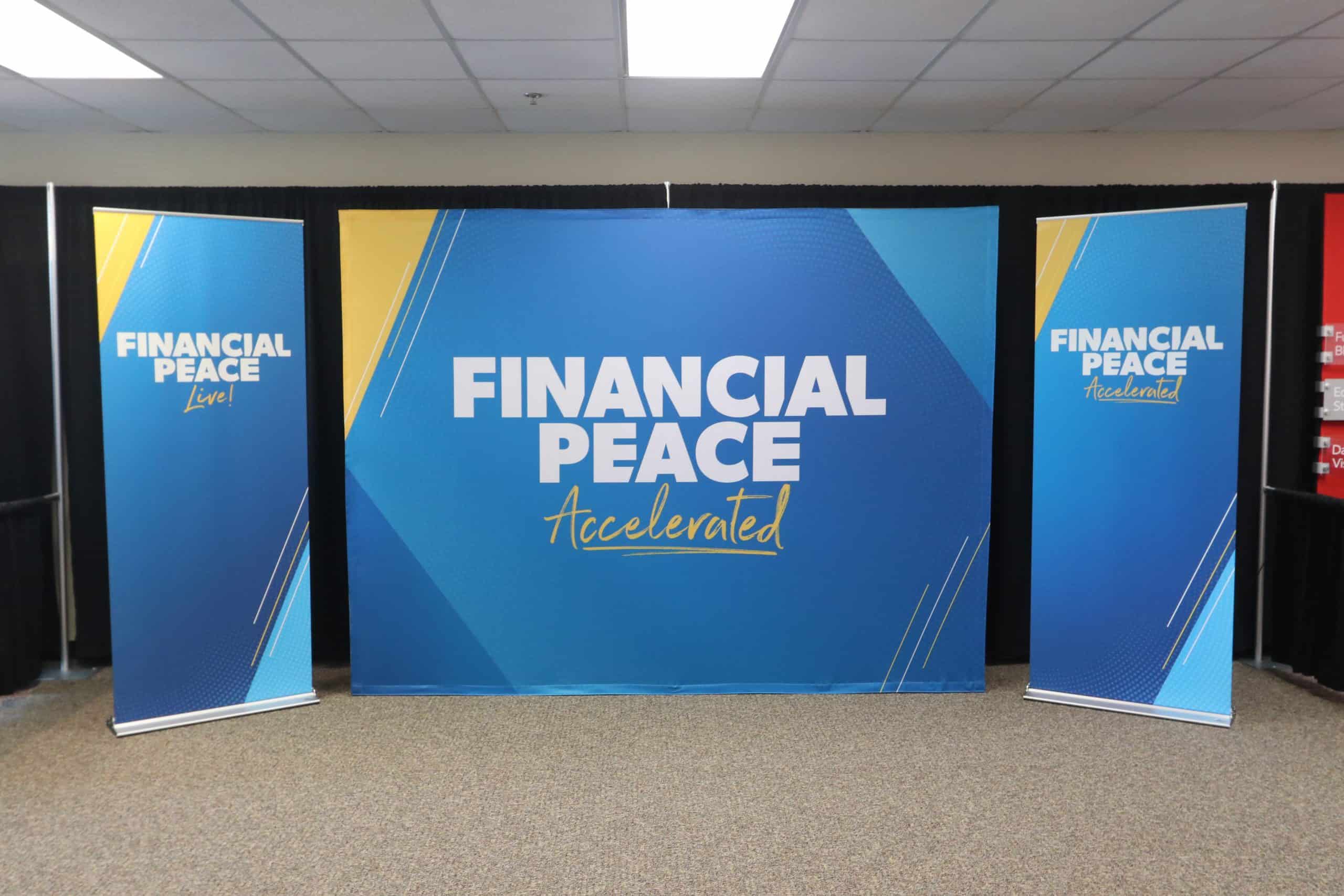 Conference room with banners reading "Financial Peace Accelerated" in blue and yellow.