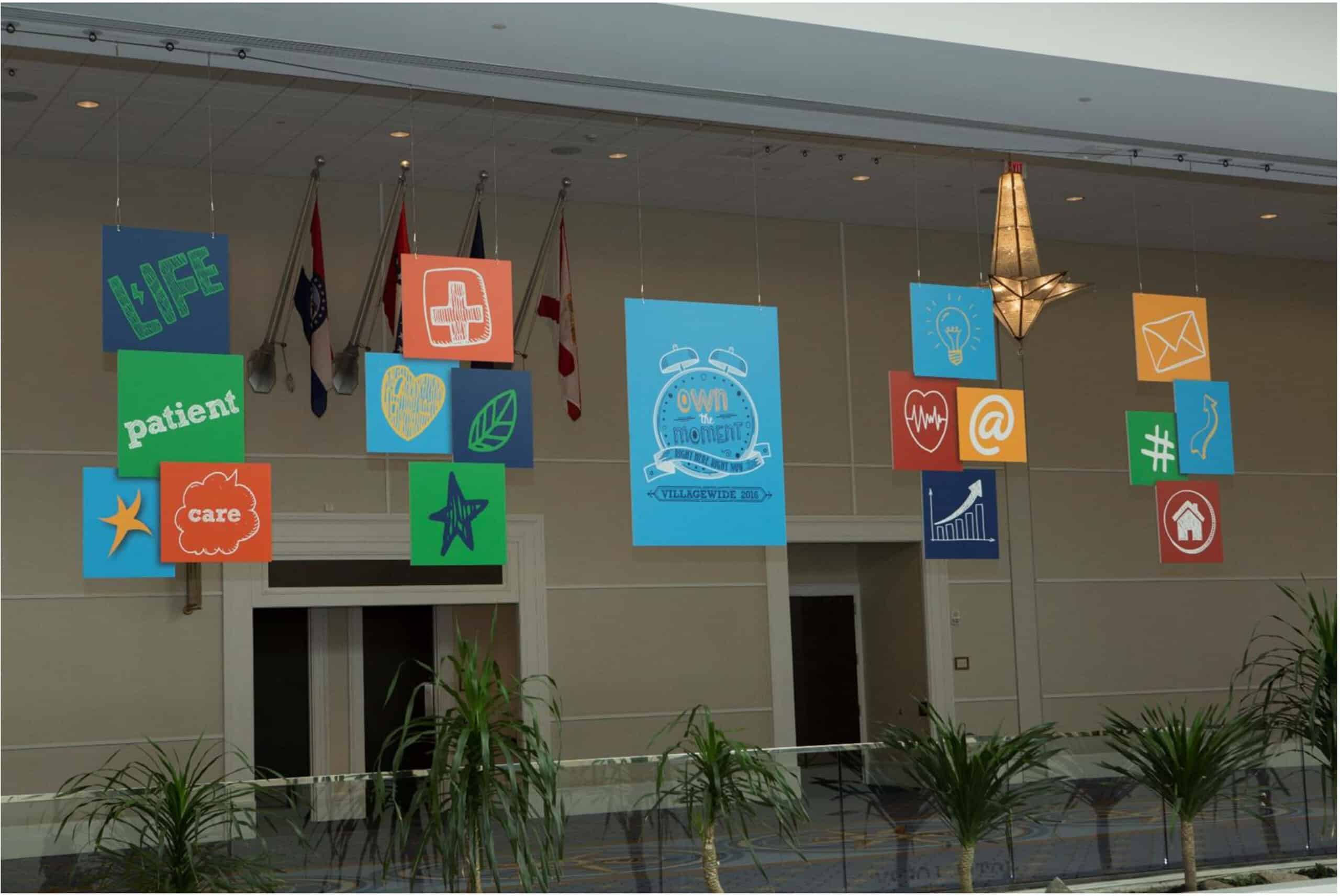 Colorful posters hanging from the ceiling enhance messaging for attendees at the company-wide convention.
