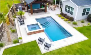 Backyard Rectangular Pool with Jacuzzi and Surrounding Hardscaping
